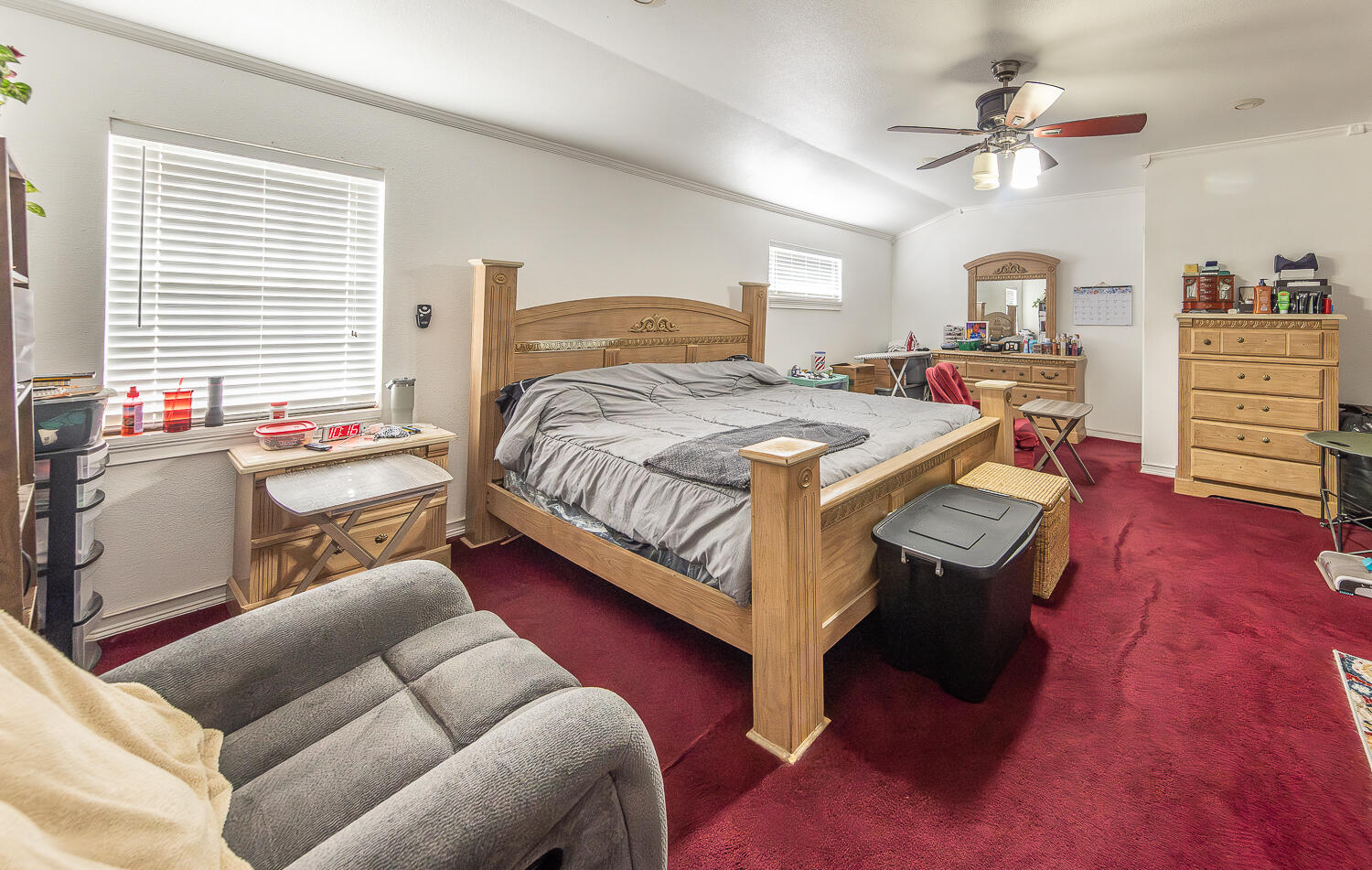 1724 East 2nd Street Lubbock, TX 79403 - Photo 7 of 20 a bedroom with a bed furniture and a chandelier