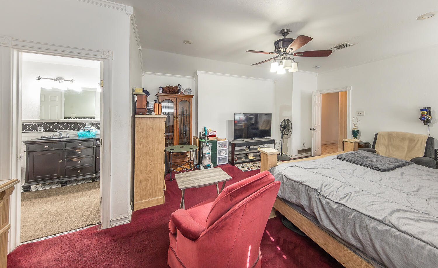 1724 East 2nd Street Lubbock, TX 79403 - Photo 8 of 20 a bedroom with a bed and a flat screen tv