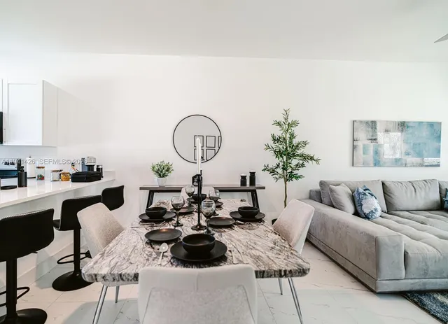 a living room with furniture and a large mirror