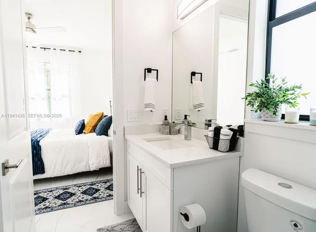 a bathroom with a sink a toilet and mirror