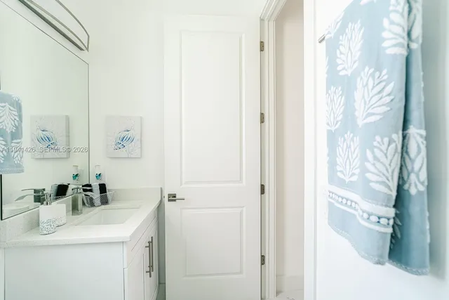 a bathroom with a sink vanity and a mirror