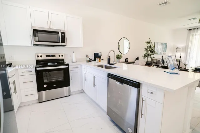 a kitchen with a sink stove and microwave