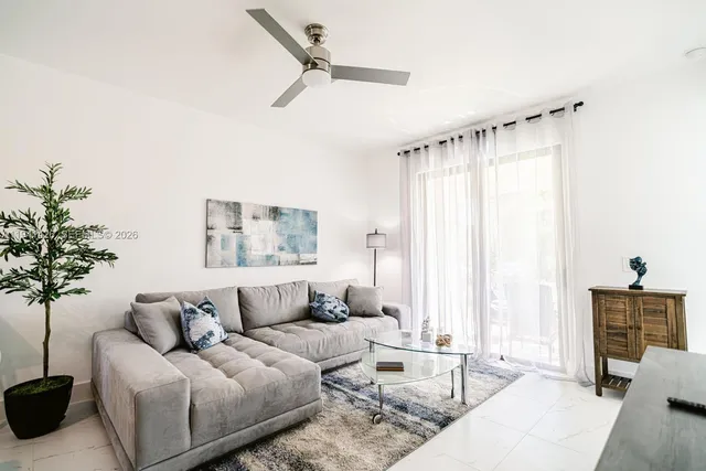 a living room with furniture and a large window