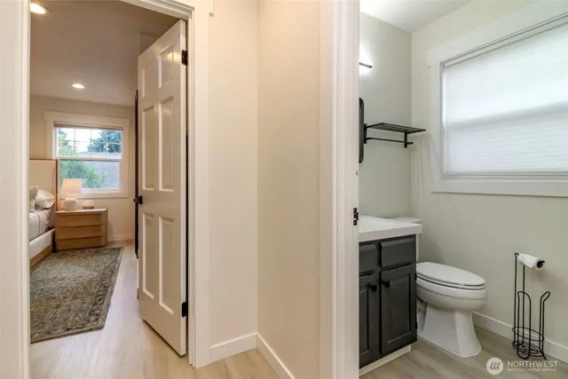 a bathroom with a toilet and a shower
