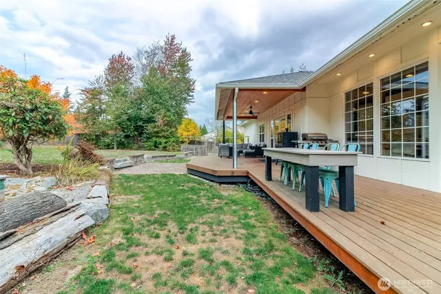 a view of a house with backyard and sitting area