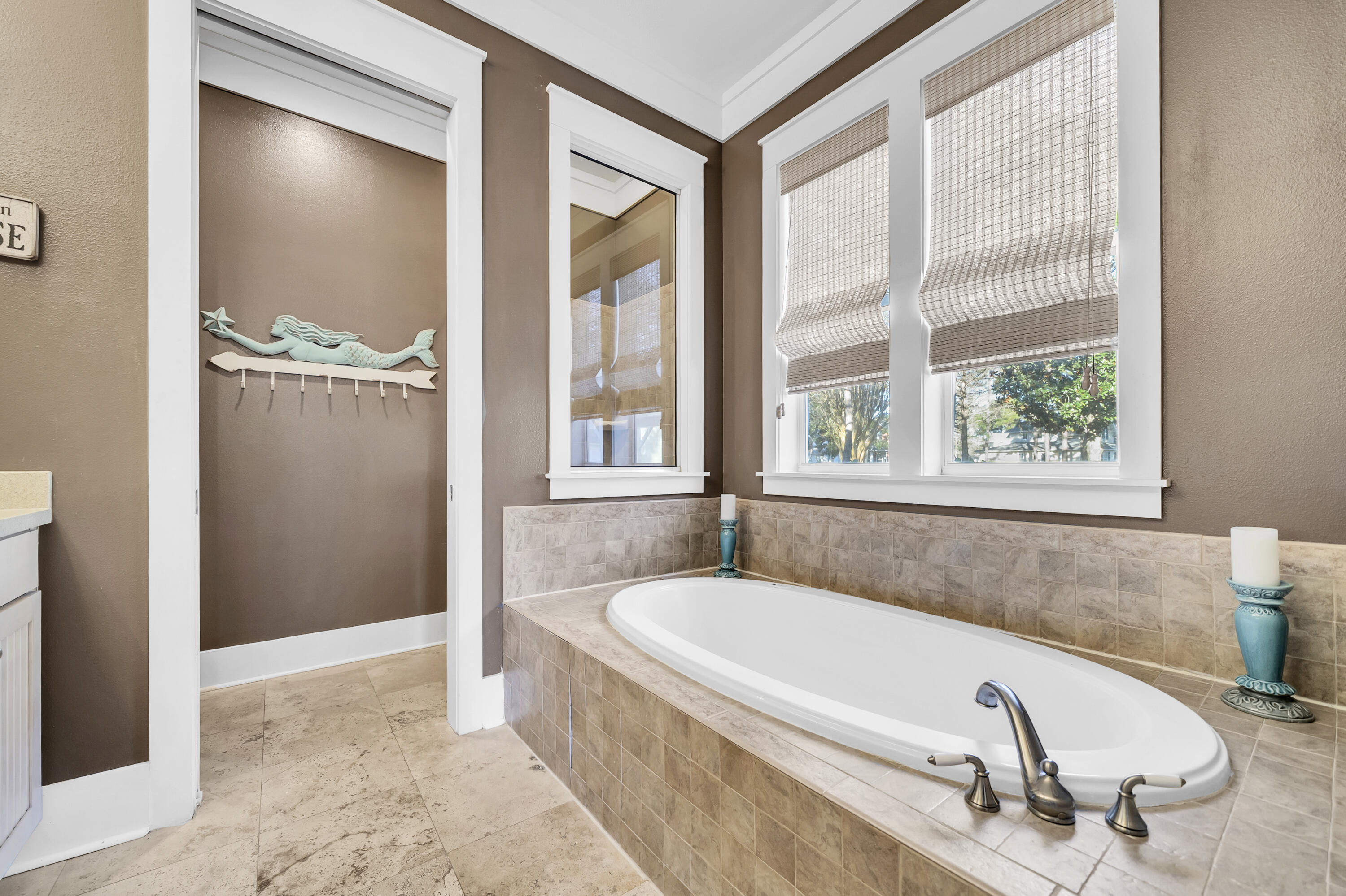 1303 Laurel Way Miramar Beach, FL 32550 - Photo 11 of 77 a bathroom with a tub and a sink