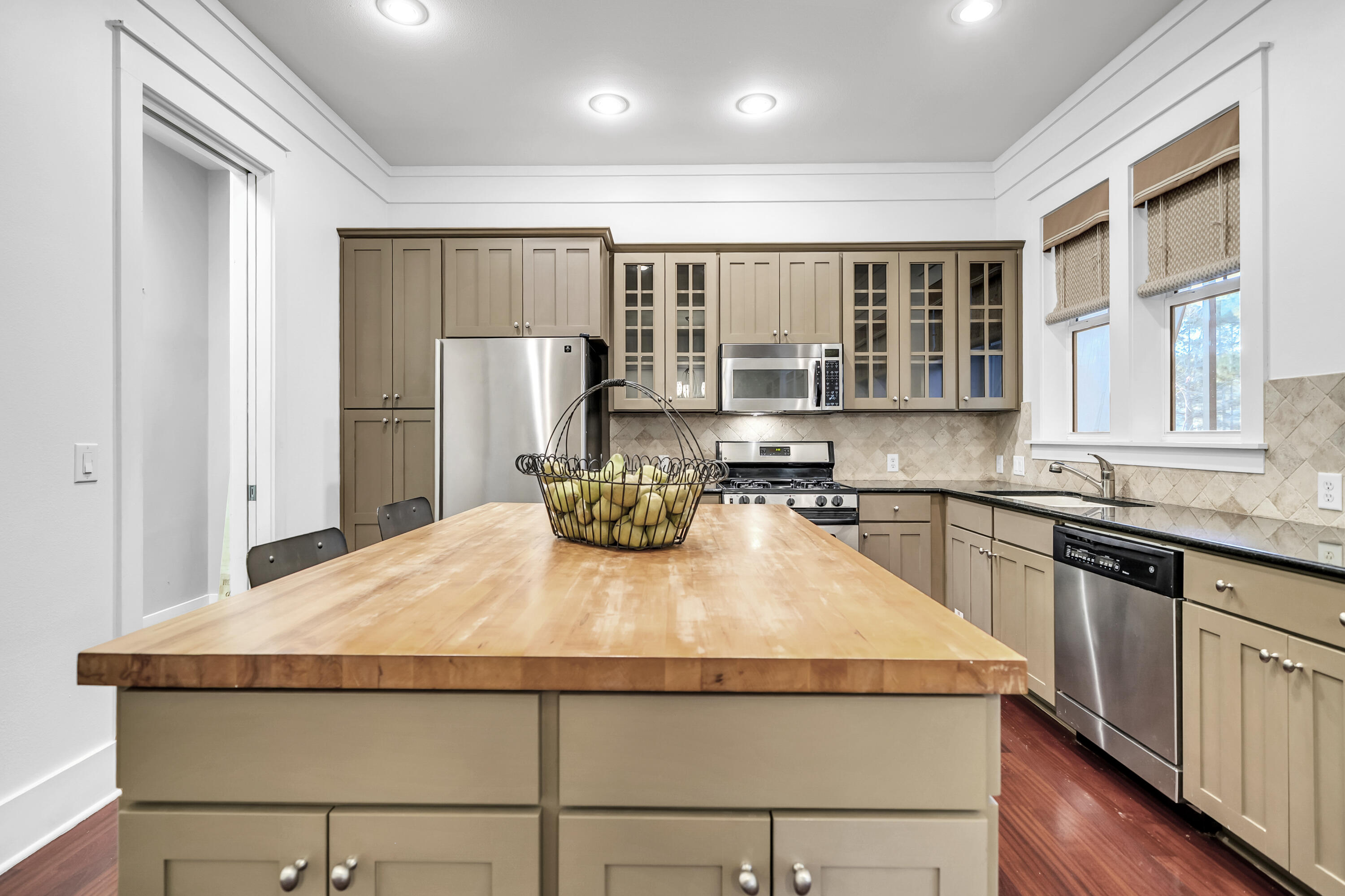 1303 Laurel Way Miramar Beach, FL 32550 - Photo 15 of 77 a kitchen with sink a refrigerator and wooden cabinets