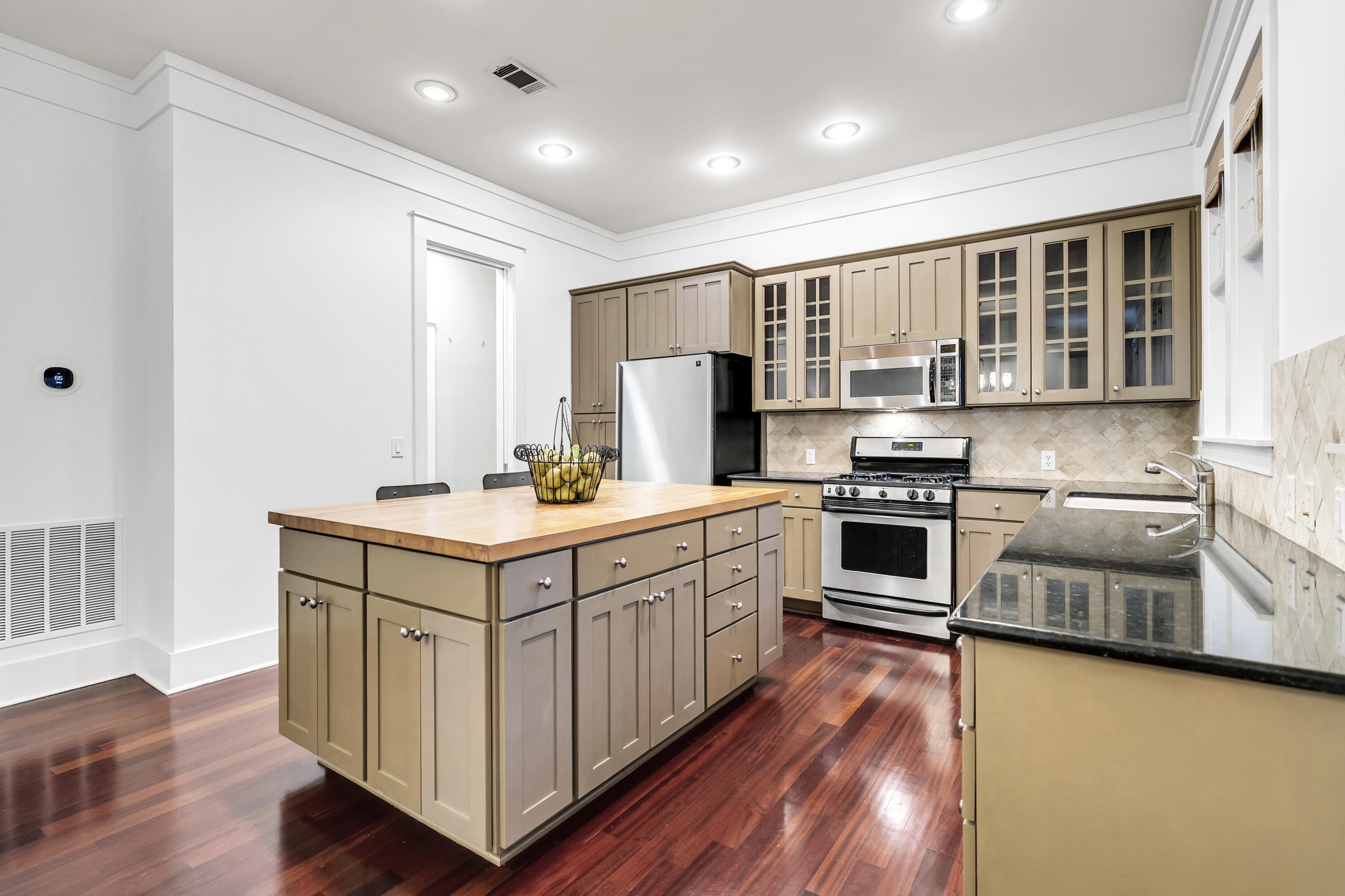 1303 Laurel Way Miramar Beach, FL 32550 - Photo 16 of 77 a kitchen with wooden cabinets and white appliances