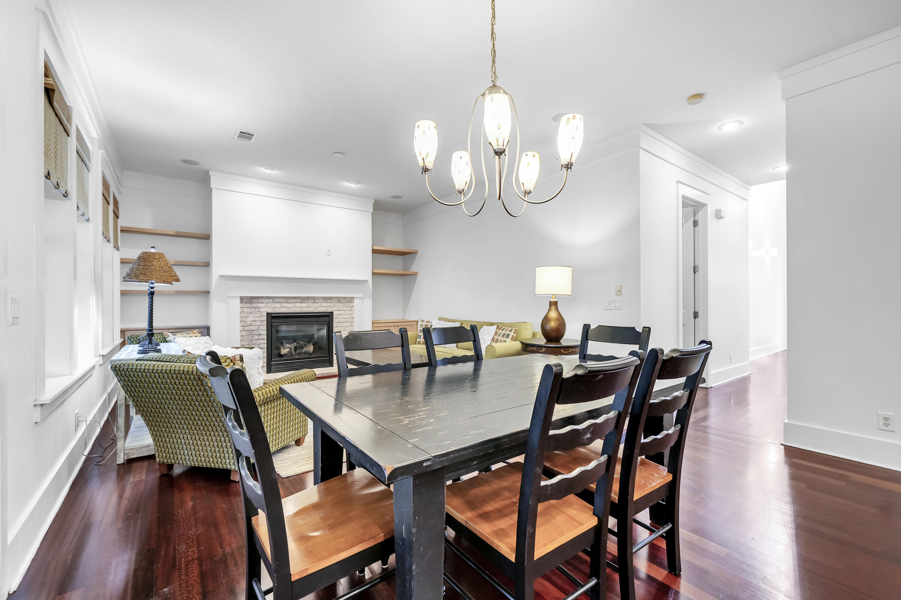 1303 Laurel Way Miramar Beach, FL 32550 - Photo 20 of 77 a view of a dining room with furniture wooden floor and chandelier