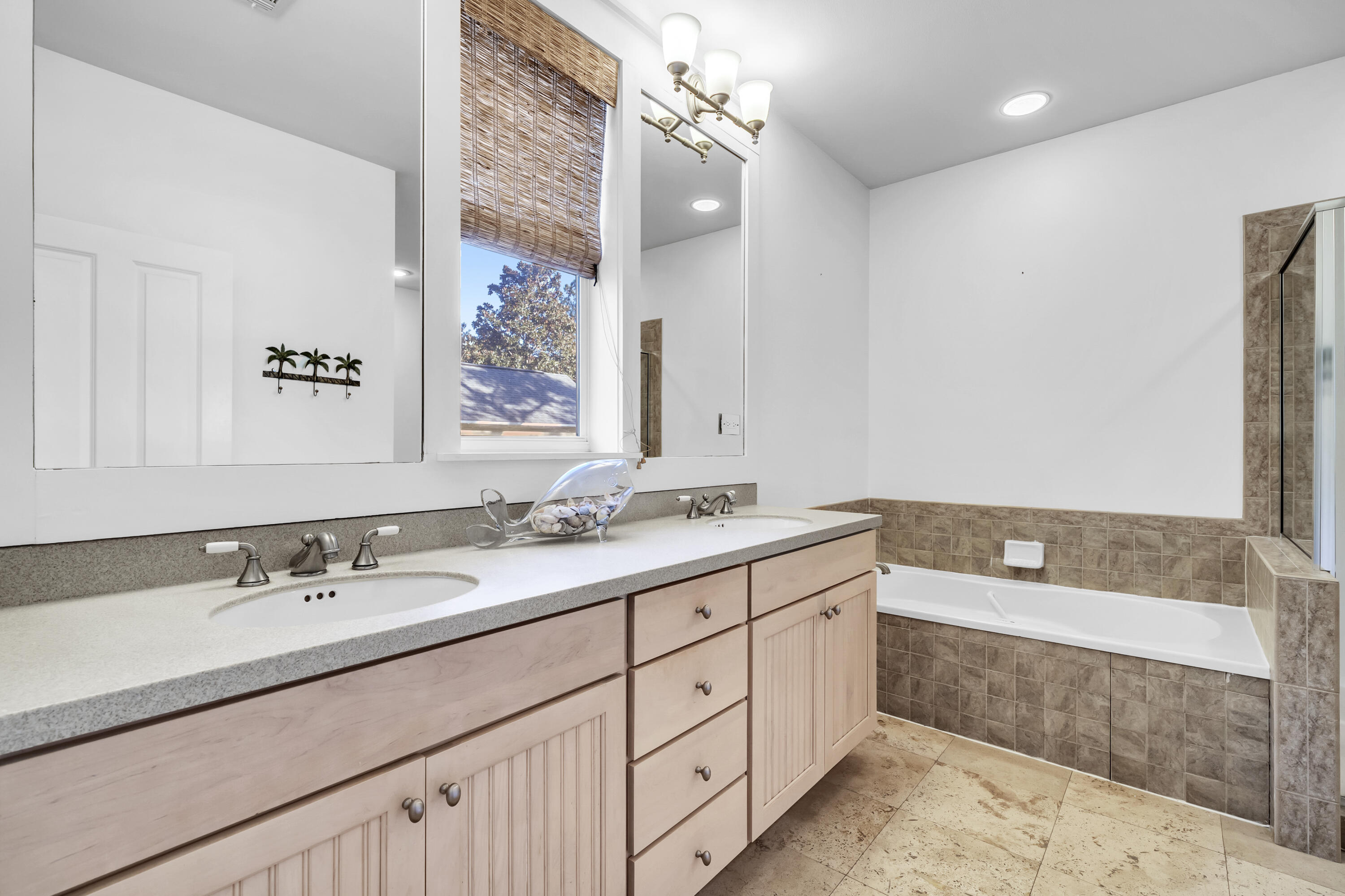 1303 Laurel Way Miramar Beach, FL 32550 - Photo 48 of 77 a spacious bathroom with a double vanity sink a mirror and a bathtub