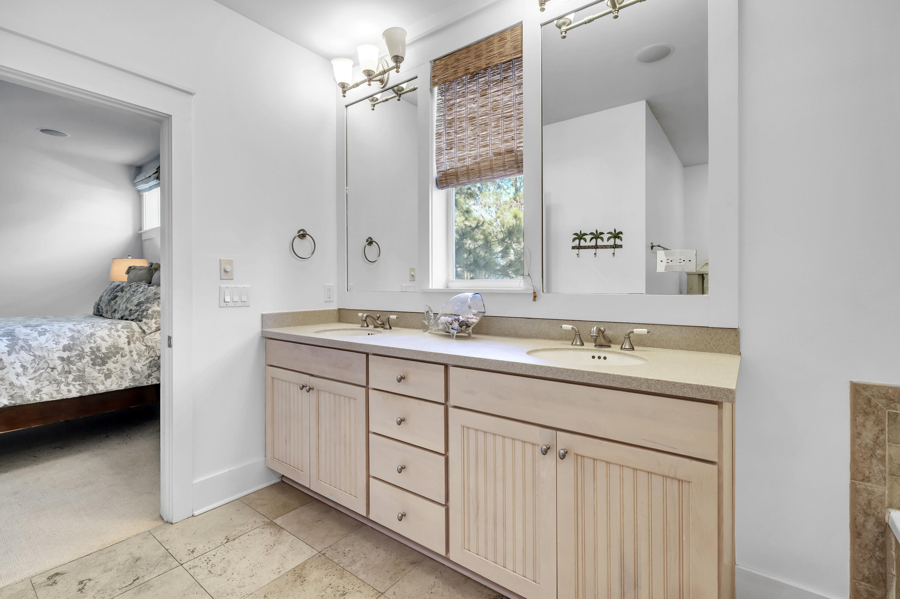 1303 Laurel Way Miramar Beach, FL 32550 - Photo 49 of 77 a bathroom with a double vanity sink and a mirror