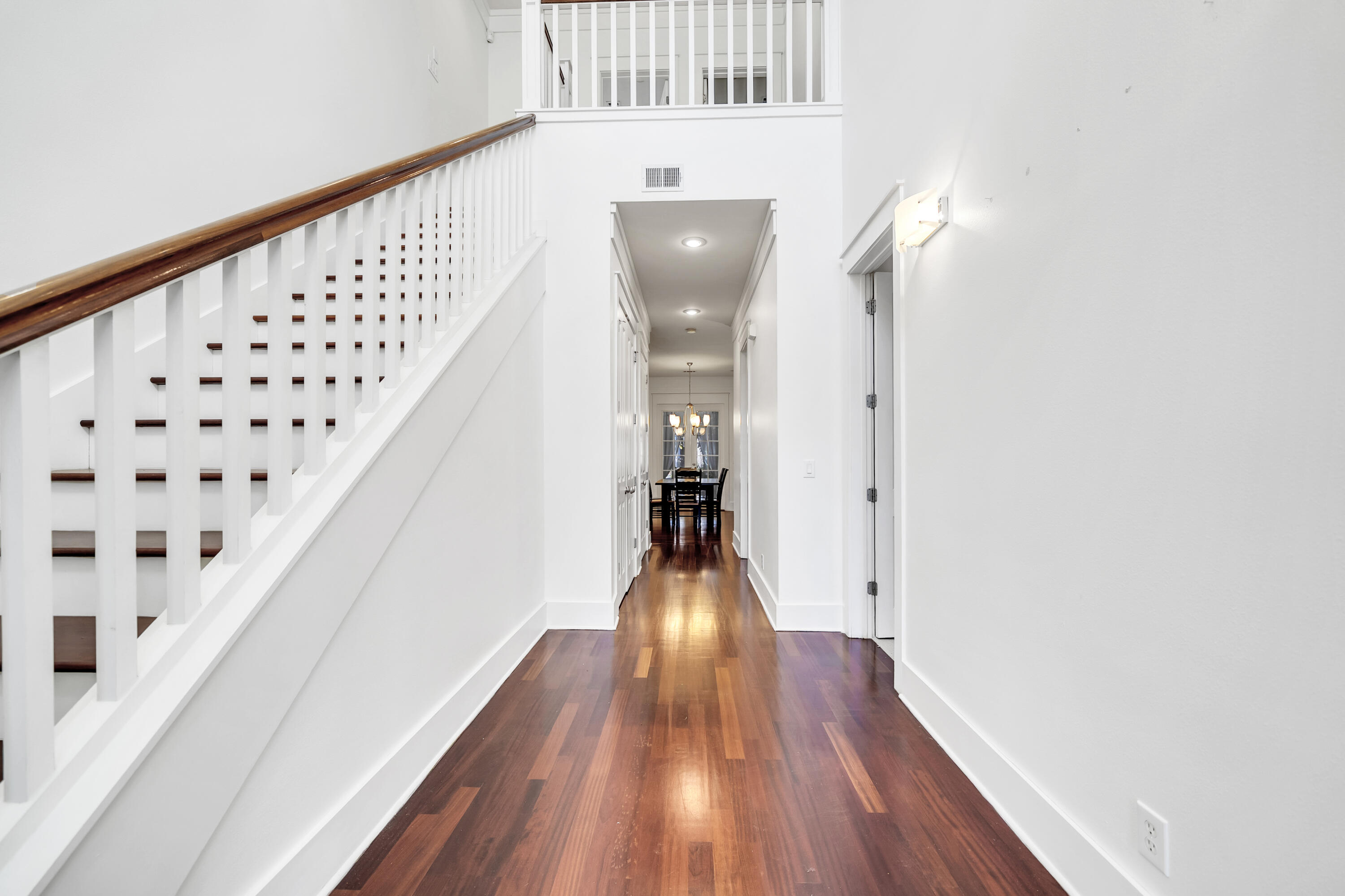 1303 Laurel Way Miramar Beach, FL 32550 - Photo 6 of 77 a view of a hallway with wooden floor and staircase