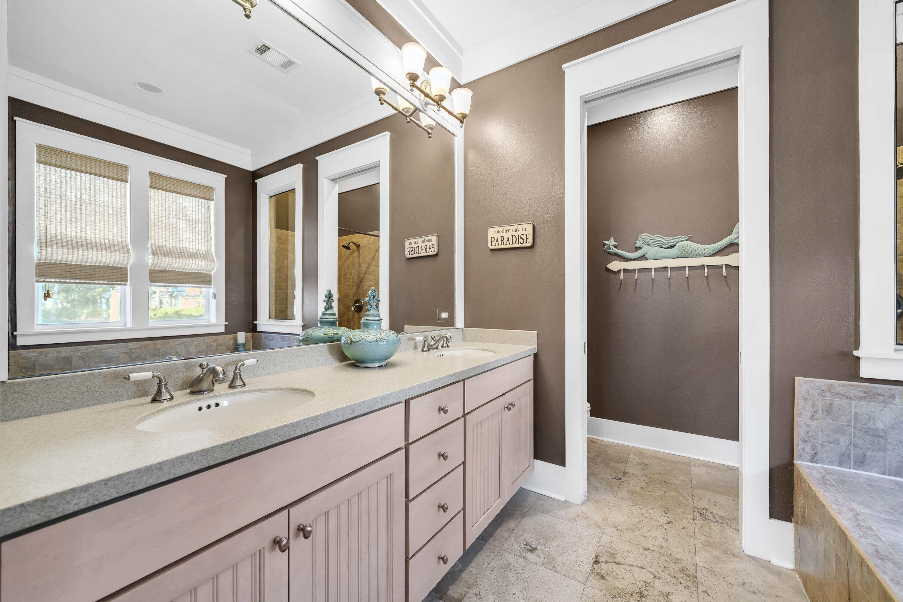 1303 Laurel Way Miramar Beach, FL 32550 - Photo 10 of 77 a bathroom with a double vanity sink and mirror with shower