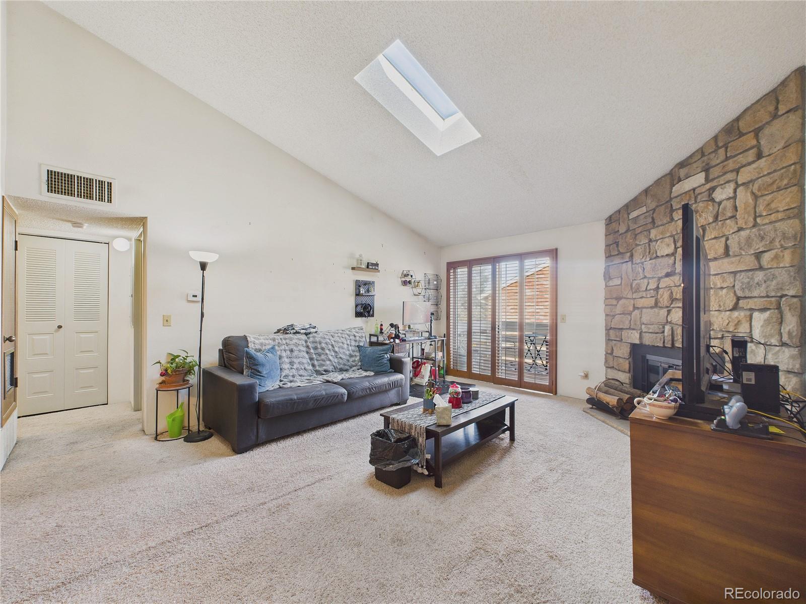 10251 West 44th Avenue, Unit 2203 Wheat Ridge, CO 80033 - Photo 17 of 20 a living room with furniture gym equipment and a large window