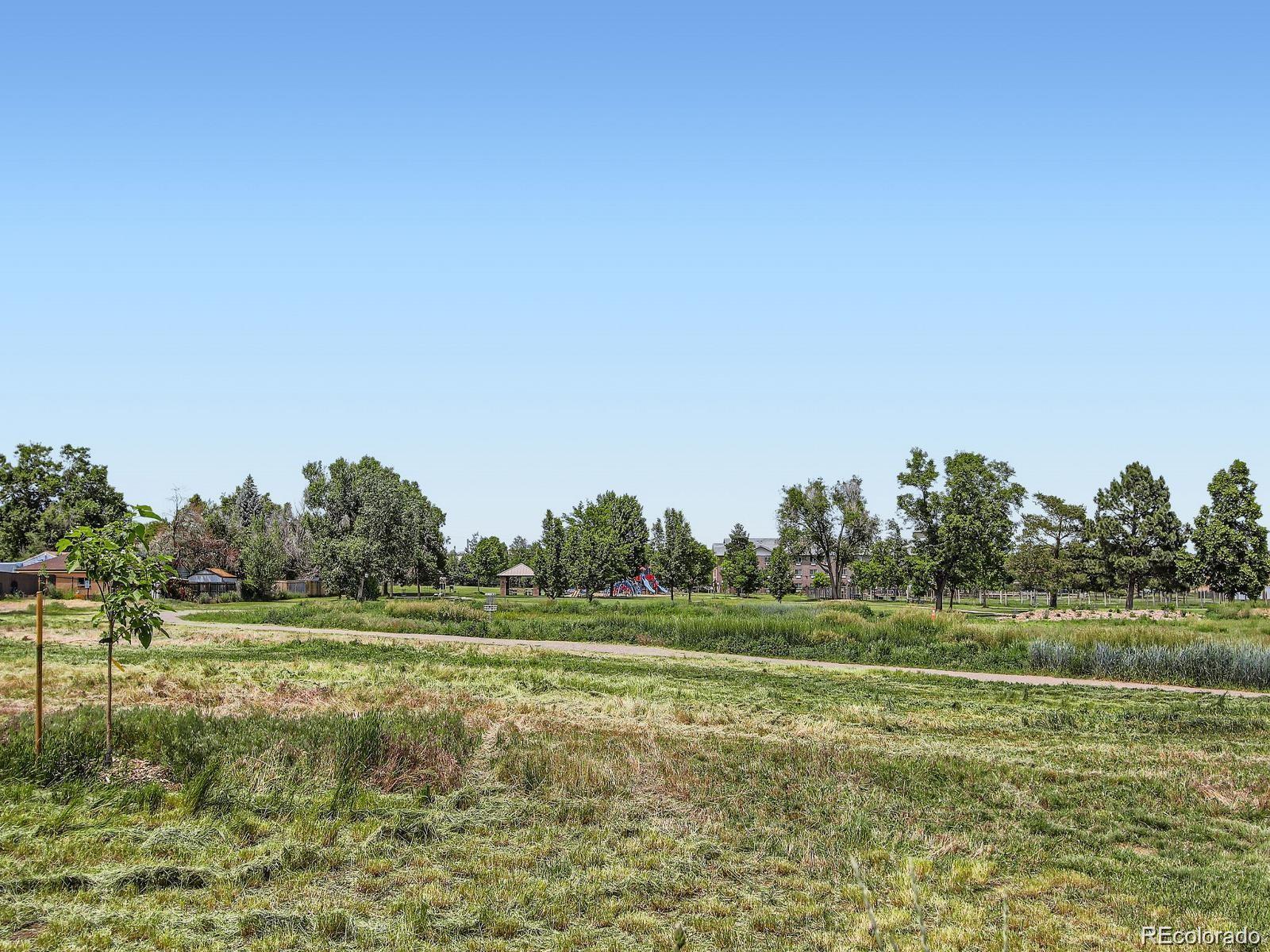 10251 West 44th Avenue, Unit 2203 Wheat Ridge, CO 80033 - Photo 18 of 20 a view of a field with trees in the background