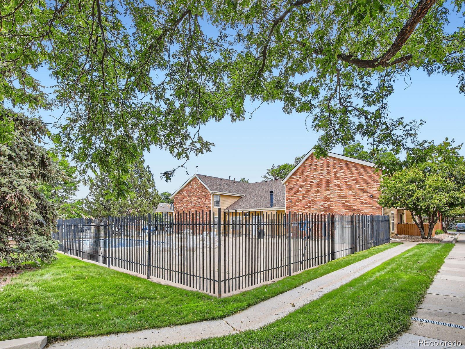 10251 West 44th Avenue, Unit 2203 Wheat Ridge, CO 80033 - Photo 19 of 20 a view of a fence and a yard