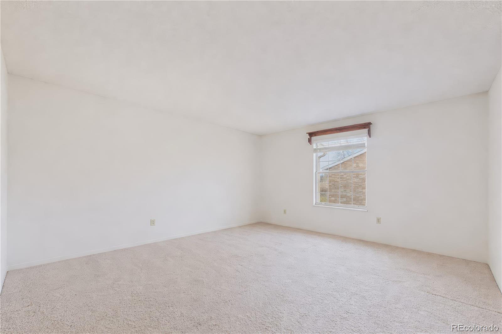 10251 West 44th Avenue, Unit 2203 Wheat Ridge, CO 80033 - Photo 9 of 20 an empty room with a empty space and windows