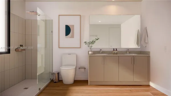 a bathroom with a sink a toilet and shower