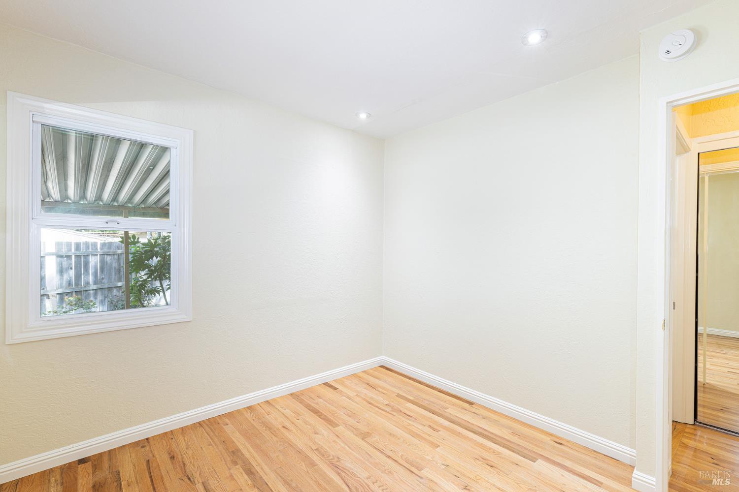 18090 Las Lomas Road Sonoma, CA 95476 - Photo 23 of 37 a view of empty room with wooden floor and fan