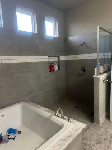 a view of walk in closet with clothes