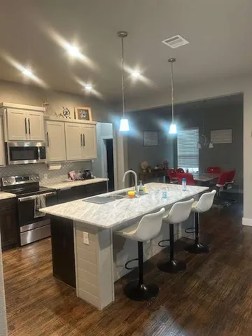 a kitchen with kitchen island granite countertop lots of counter top space