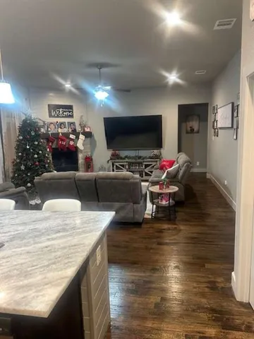 a living room with furniture window and wooden floor