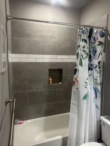 a bedroom with a bed and a tv