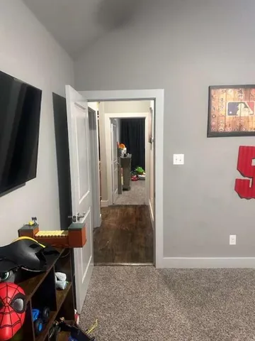 a shelf with wine bottles and glasses on it