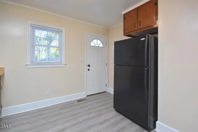 an empty room with wooden floor and a window