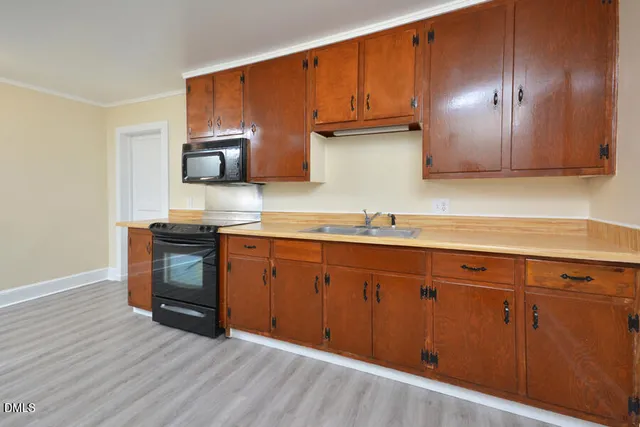 a kitchen with wooden cabinets and a sink