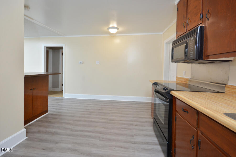 721 Peyton Avenue Durham, NC 27703 - Photo 13 of 25 a kitchen with granite countertop a sink and a stove top oven