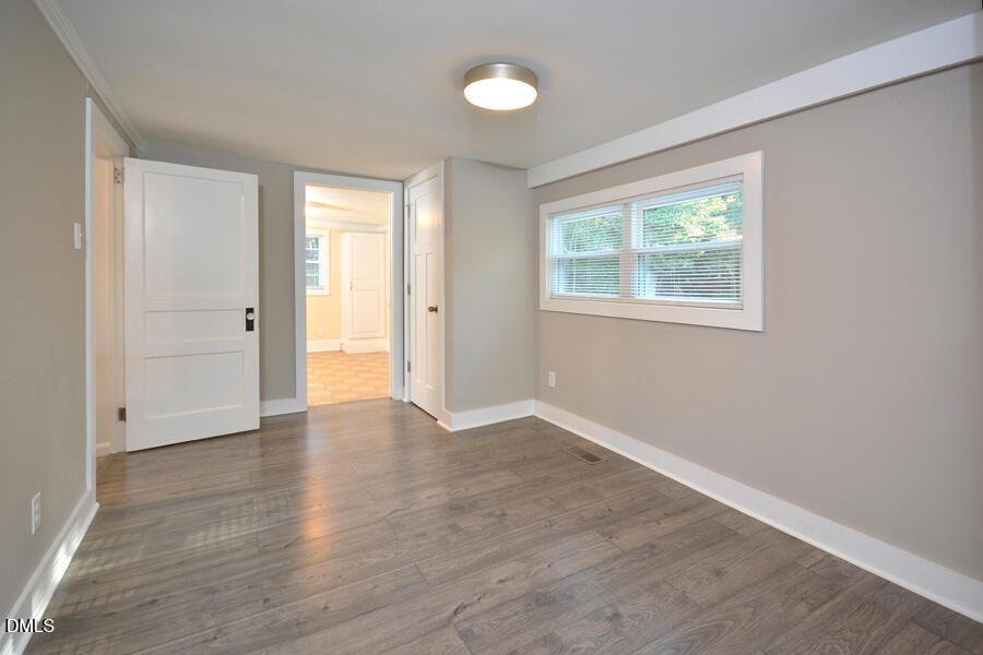 721 Peyton Avenue Durham, NC 27703 - Photo 21 of 25 an empty room with wooden floor and windows