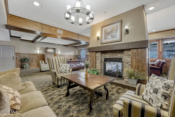 a living room with furniture and a chandelier