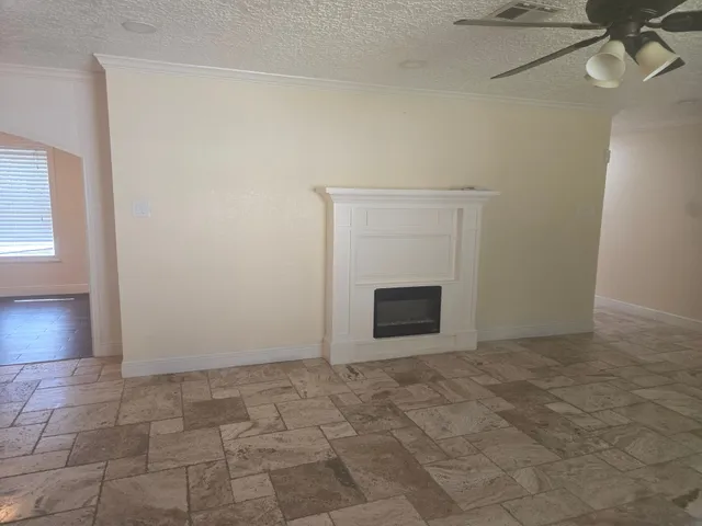a view of an empty room with a fireplace