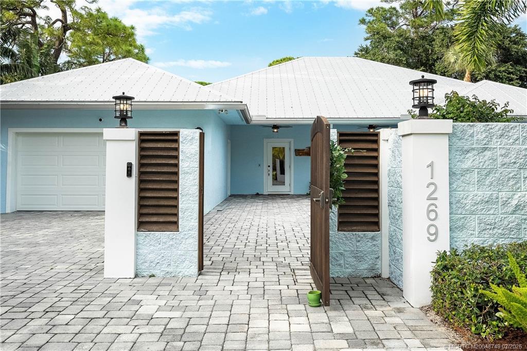 1269 Northwest Fork Road Stuart, FL 34994 - Photo 11 of 92 a view of a entrance gate of the house