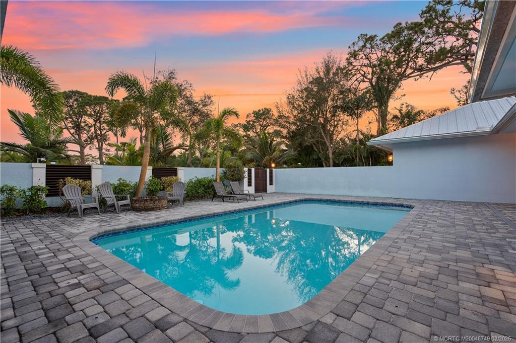 1269 Northwest Fork Road Stuart, FL 34994 - Photo 14 of 92 a view of a swimming pool with a sitting space