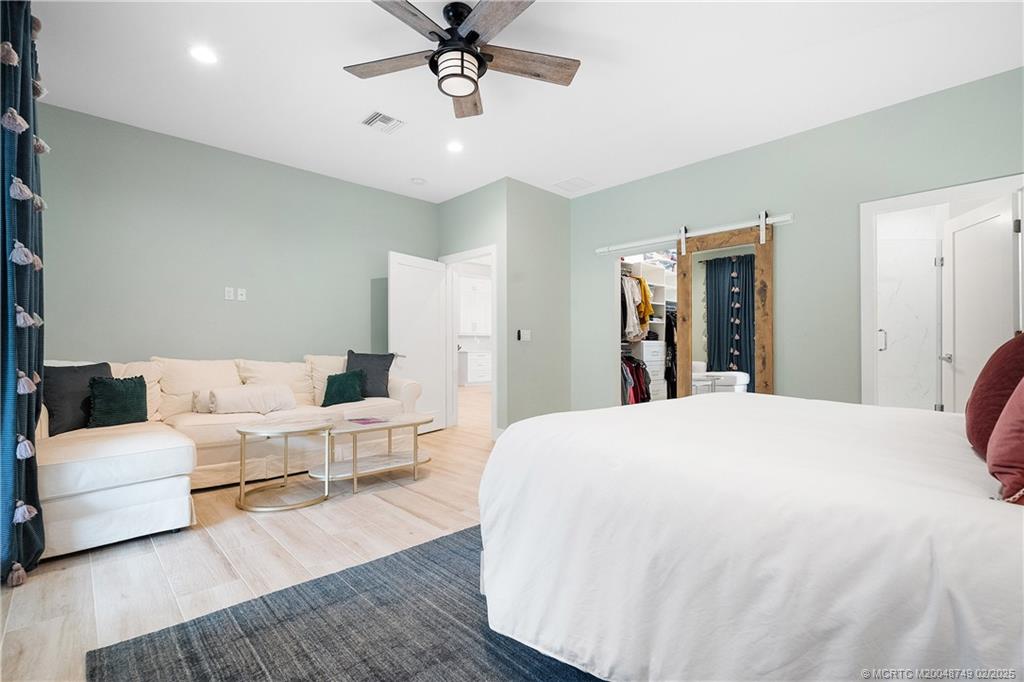 1269 Northwest Fork Road Stuart, FL 34994 - Photo 43 of 92 a bed room with a bed and a chandelier