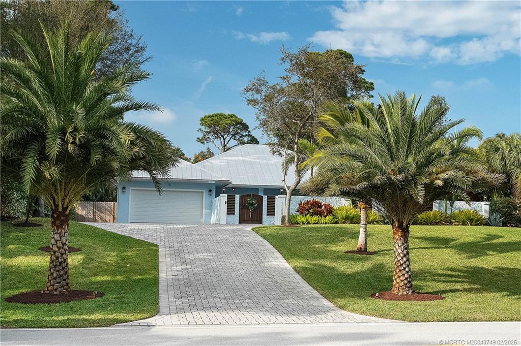 1269 Northwest Fork Road Stuart, FL 34994 - Photo 5 of 92 a front view of a house with garden