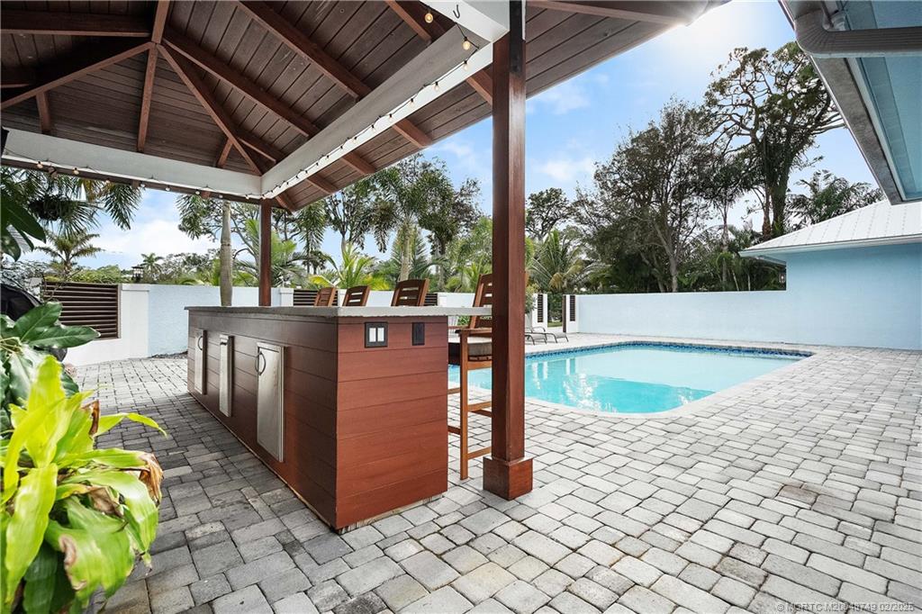 1269 Northwest Fork Road Stuart, FL 34994 - Photo 63 of 92 a view of a backyard with wooden fence