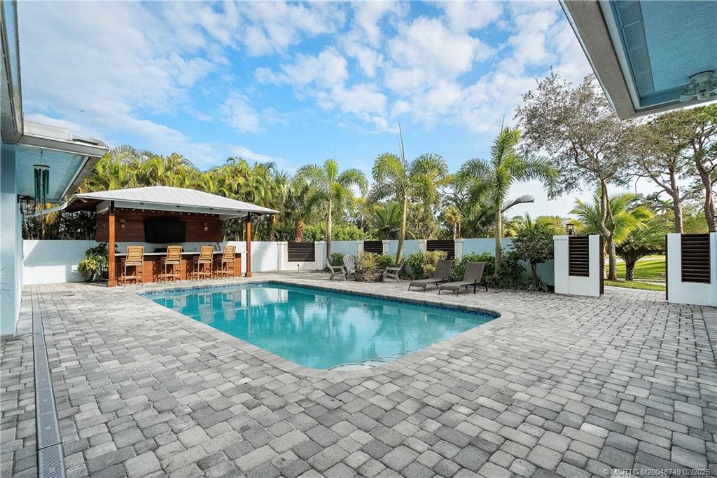 1269 Northwest Fork Road Stuart, FL 34994 - Photo 70 of 92 a view of a swimming pool with a patio