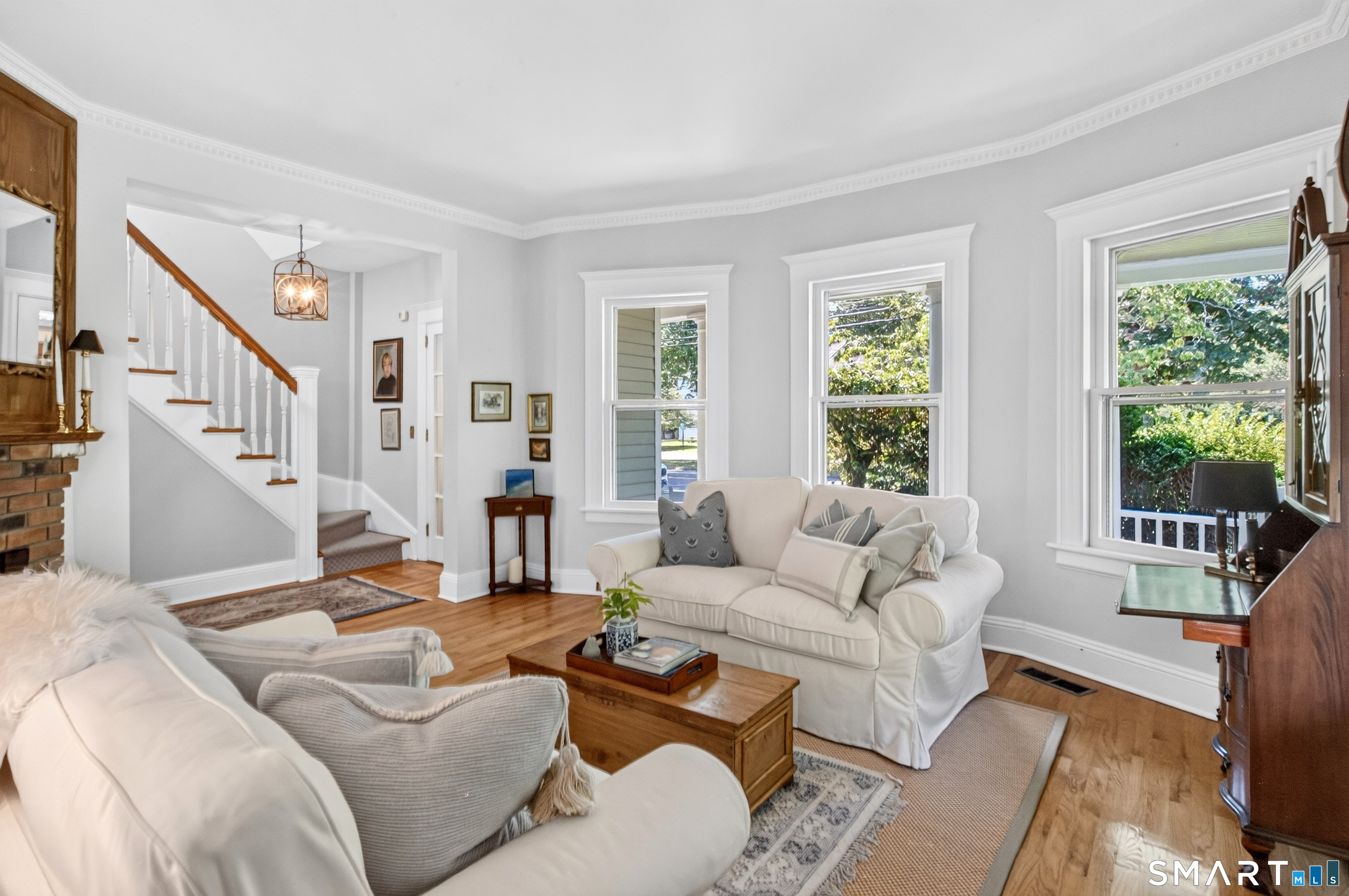 239 Beach Road Fairfield, CT 06824 - Photo 7 of 40 Living room facing windows that look out to the front porch.