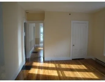 a view of bedroom with wooden floor