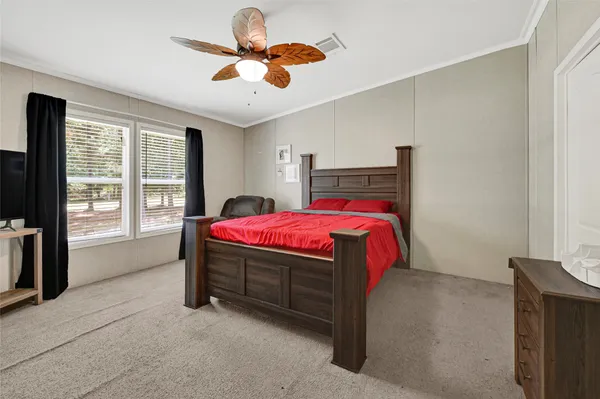 a bedroom with a bed closet and window