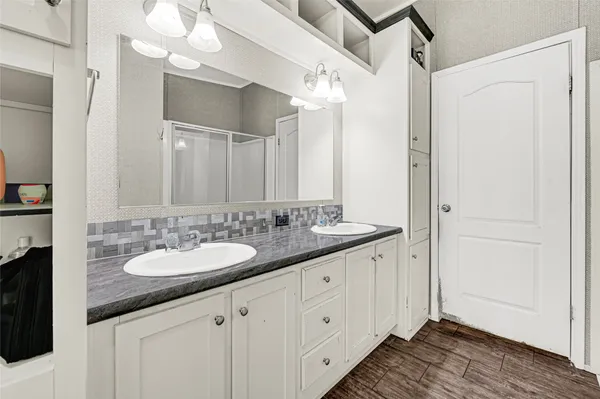a bathroom with a sink a vanity and a mirror