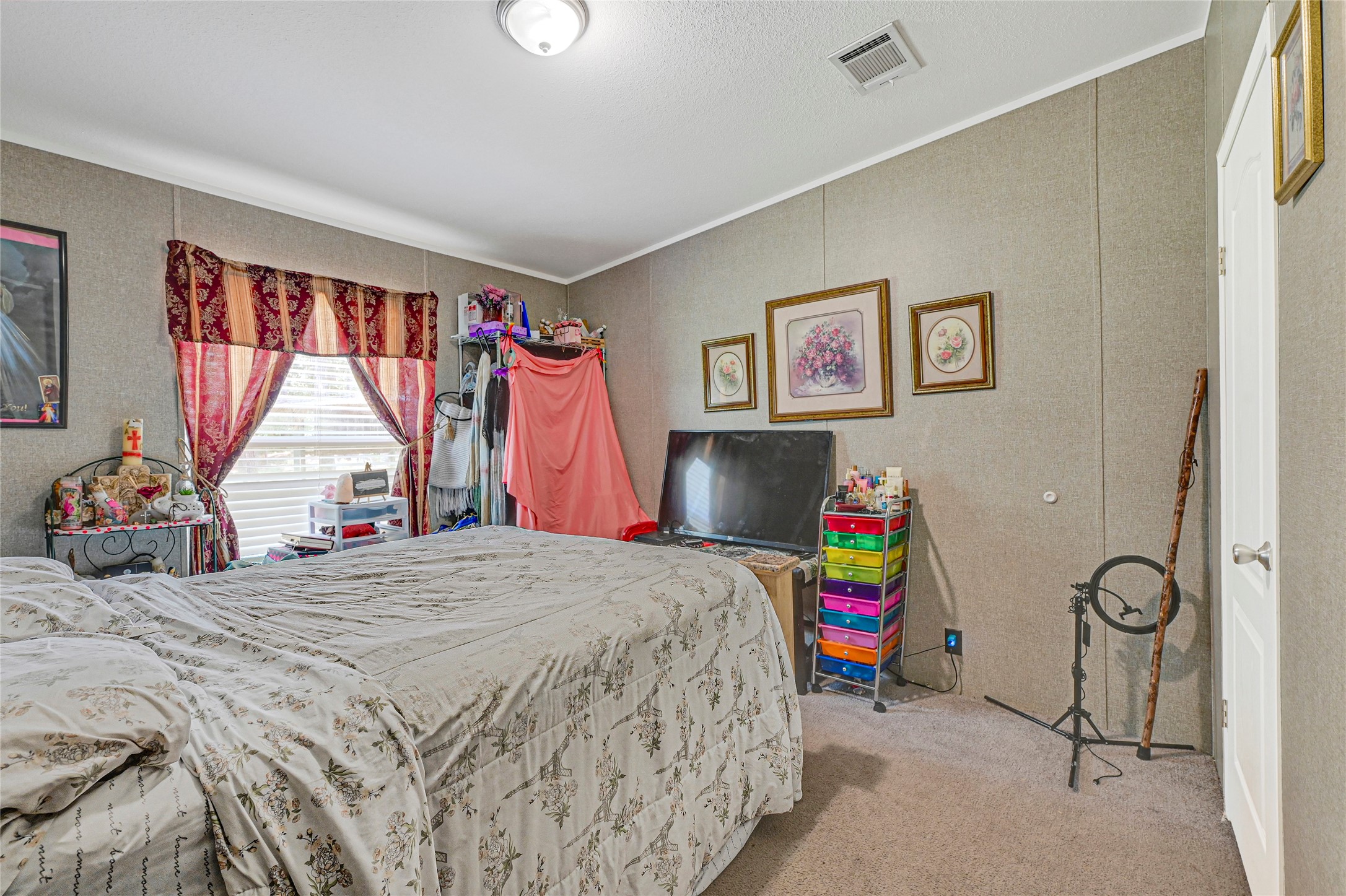 635 County Road 2175 Shepherd, TX 77371 - Photo 18 of 27 a bedroom with a bed a standing and a large window