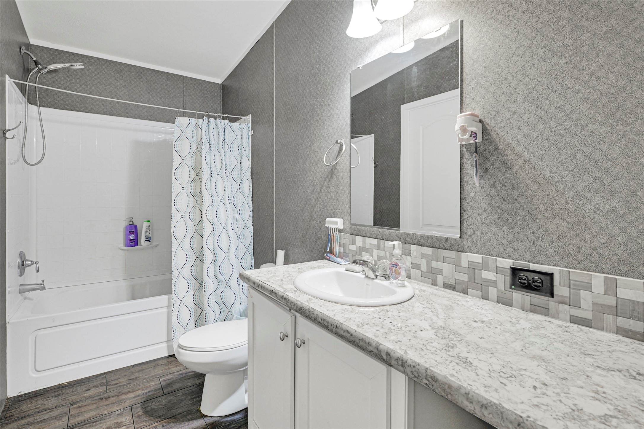 635 County Road 2175 Shepherd, TX 77371 - Photo 22 of 27 a bathroom with a granite countertop sink toilet and shower
