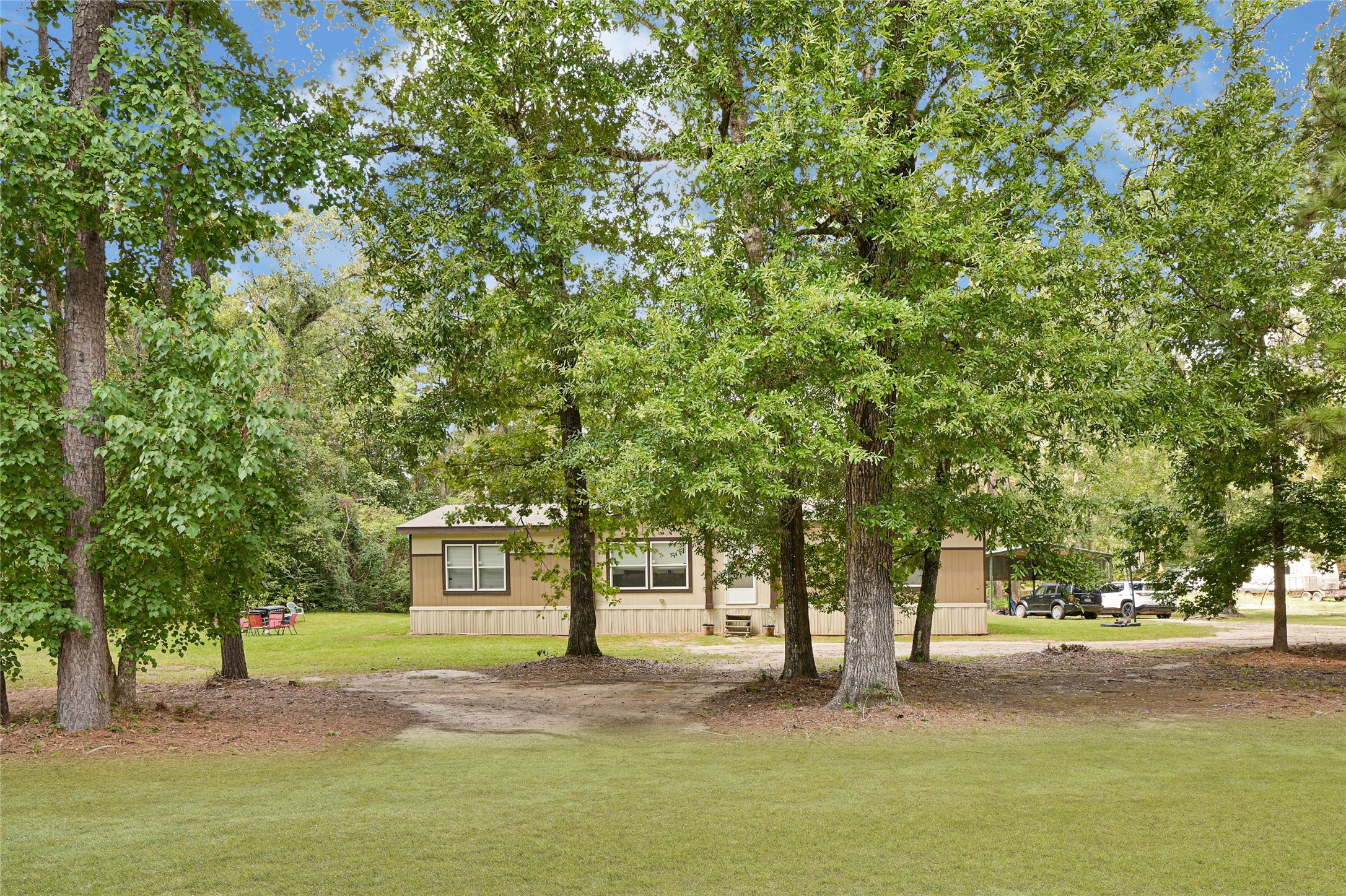 635 County Road 2175 Shepherd, TX 77371 - Photo 24 of 27 a house with trees in front of it