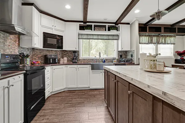 a kitchen with a sink stove and microwave