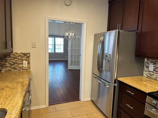 a kitchen with stainless steel appliances granite countertop a refrigerator and a sink