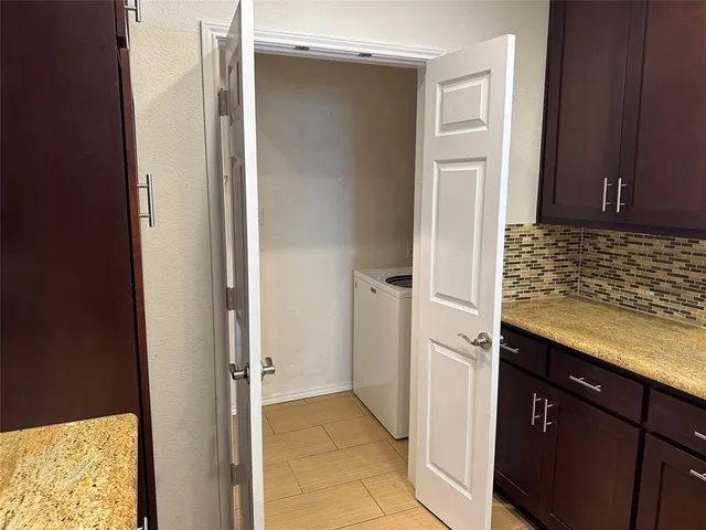 a view of kitchen with a refrigerator and cabinets